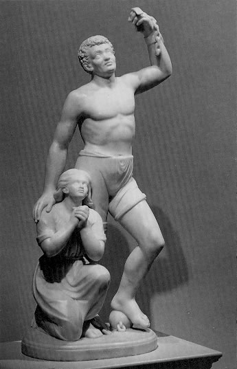 Forever Free, marble sculpture by Edmond Lewis, showing a man standing holding broken shackles and sheltering a praying child